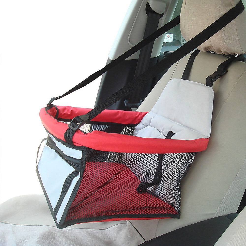 Dog car booster seat installed on a rear car seat with adjustable straps and breathable mesh sides
