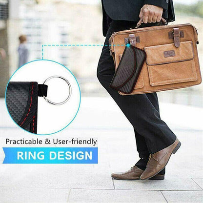 Person holding a brown leather briefcase with a close-up of a ring design feature on faraday pouch