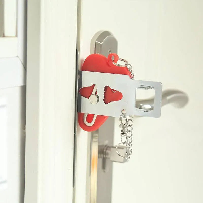 Portable hotel door lock in red  attached to a door handle.