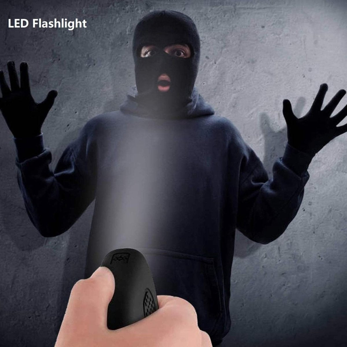 LED flashlight on rechargeable personal safety alarm illuminating an intruder at night
