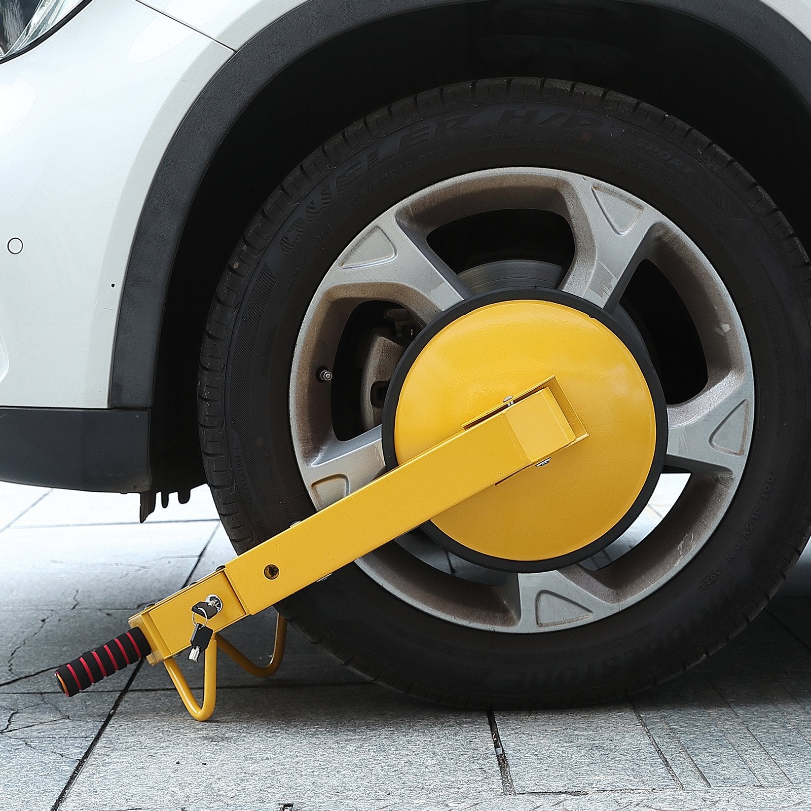 Yellow car wheel clamp on a car tyre
